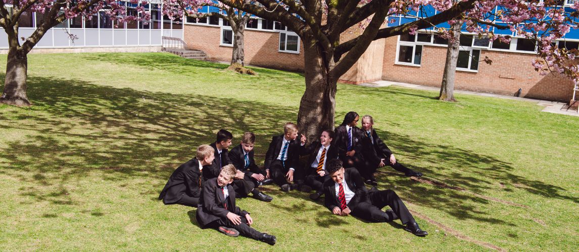school pupils sat under tree
